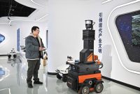 A staff member of Tianjin Siasun Intelligent Technology operates a mine inspection robot in the Beijing-Tianjin Zhongguancun Tech Town in Tianjin.